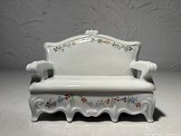Front view showing bench shape, floral decoration and scalloped border