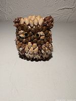 Front view of seashell owl figurine showing facial detail and eyes