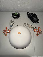 Subwoofer, both satellites, power adapter and cables laid out