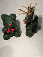 Two tabletop pine topiary figures, deer and bear