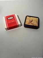 Coasters stacked beside Pimpernel box