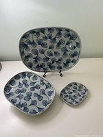 Front view showing all three porcelain pieces with floral pattern