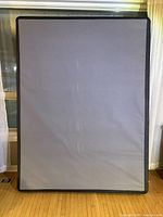 Front view of gray box spring with black edging