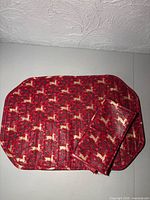 Stack of holiday placemats showing pattern and vinyl coating