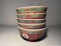 Stacked view of five famille rose bowls side motif visible