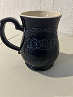 Front view showing raised Shepherd Neame 1698 lettering and handle