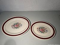 Both oval platters top view showing size difference and pattern