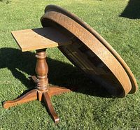 Table on its side showing pedestal base and removable square mounting block