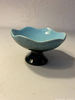 Side view of pedestal compote showing color, shape and pedestal base