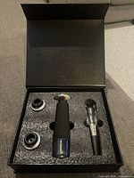 Open presentation box showing vacuum pump, aerator and two stoppers in foam cutouts