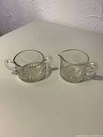 creamer and sugar bowl side by side
