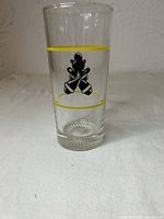 Full view of glass showing yellow bands and black crossed paddle decal