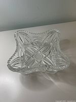 Top view of square clear crystal bowl showing star pattern and wavy rim