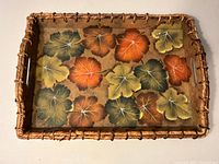 Top view showing full painted leaf pattern and wicker rim