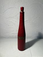 Full view of red wooden bottle