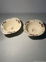 Pair of ivory earthenware serving bowls with floral rim design