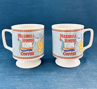 Front view of both Maxwell House pedestal mugs