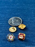 Dime with two buttons front and back for scale and detail