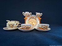 Group view of all miniature porcelain tea pieces