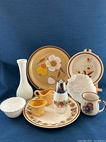 Group shot showing all stoneware plates, milk glass pieces, mug and basket weave cream and sugar