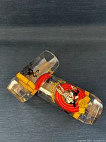 Two Warner Bros. Bugs Bunny 50th Anniversary glasses showing colour and black-white graphics