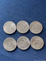 Six reverse sides showing eagle landing design and ONE DOLLAR denomination