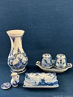 Front view of all seven Delft ceramic pieces