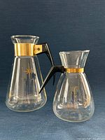 Front view of both carafes showing patterns, handles and collars