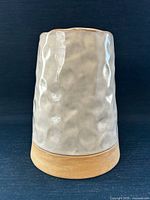 Front view showing textured glazed body and unglazed base