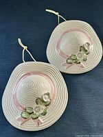 Front view of both ceramic hat planters showing design and matching appearance