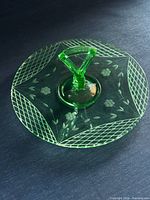 Top view of green uranium glass tray showing handle and etched pattern