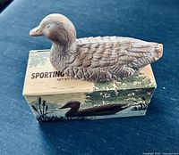Duck soap resting on its illustrated box