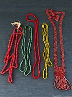Five beaded pieces laid out showing full lot