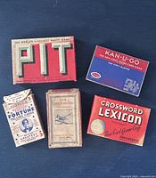 Five boxed vintage card games laid out closed