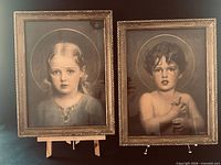 Both framed prints side by side on easel