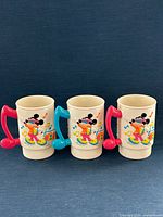 Front view showing all three mugs and handle colors