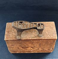 Top view of wooden shoeshine box with cast-iron star foot rest