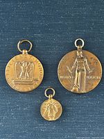 Front view of three medals showing obverse designs