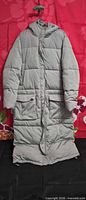 Front view of light gray 2NDDAY long puffer coat showing length, pockets, closure, hood