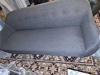 Front view of grey three-seat sofa showing full seat and backrest