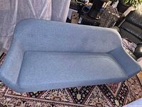 Front view of blue fabric sofa showing seat, backrest and arms