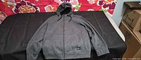 Front view of charcoal O'Neill full-zip hoodie laid flat