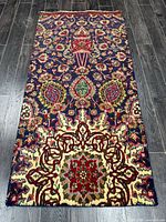Full view of Persian Tabriz runner rug on dark wood floor