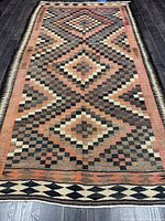 Full view of entire kilim rug laid out on floor