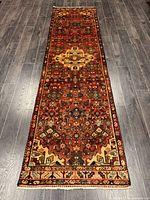 Top view full length of Persian Hamadan runner rug on hardwood floor