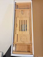 Bamboo bath caddy tray in original box, showing natural bamboo construction and integrated holders