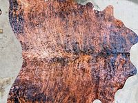 Top view of full brown brindle synthetic faux hide rug