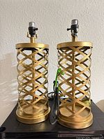Both gold metal lattice table lamps front view