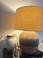 Lamp, vase and knot displayed together