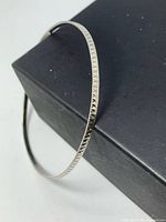 Full view of sterling silver bangle showing diamond-etched pattern